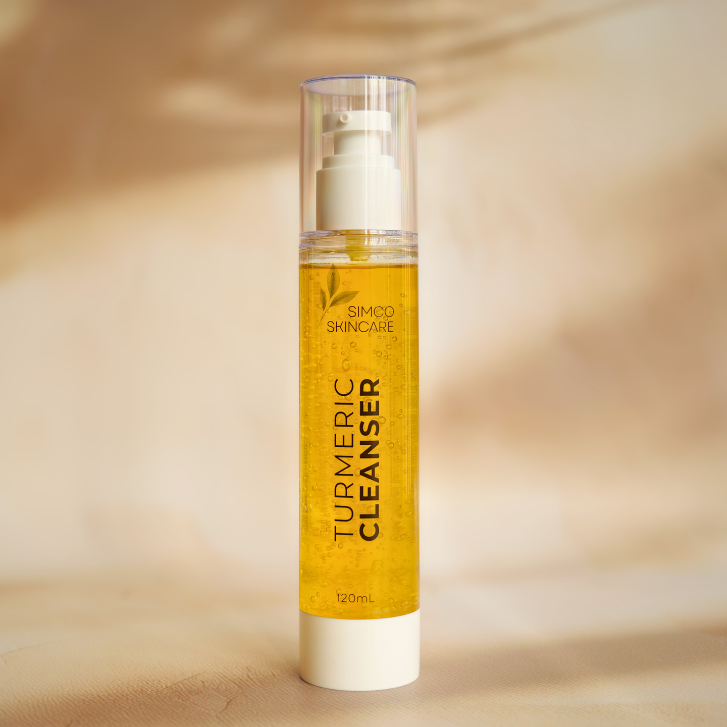 Turmeric cleanser bottle with pump on a beige background